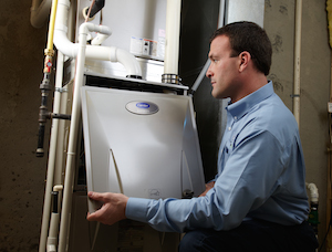 Tech looking at heat exchanger